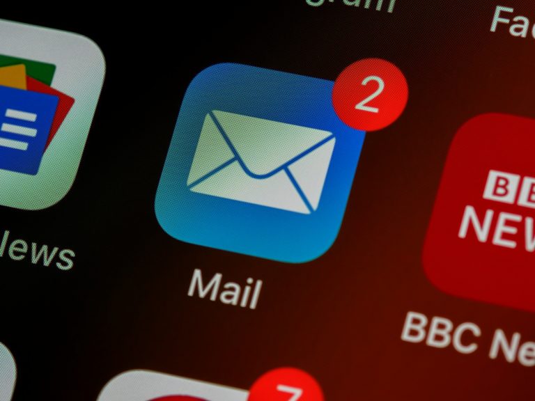 Close-up of an email app icon with unread messages on a smartphone screen