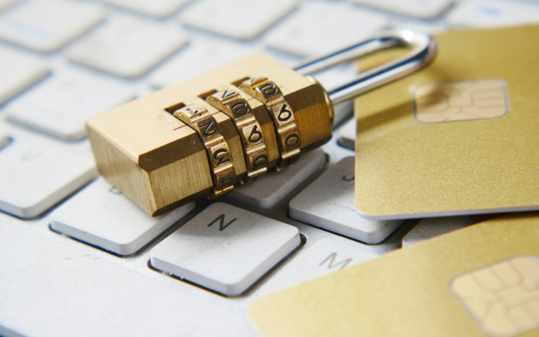 Gold padlock resting on a computer keyboard